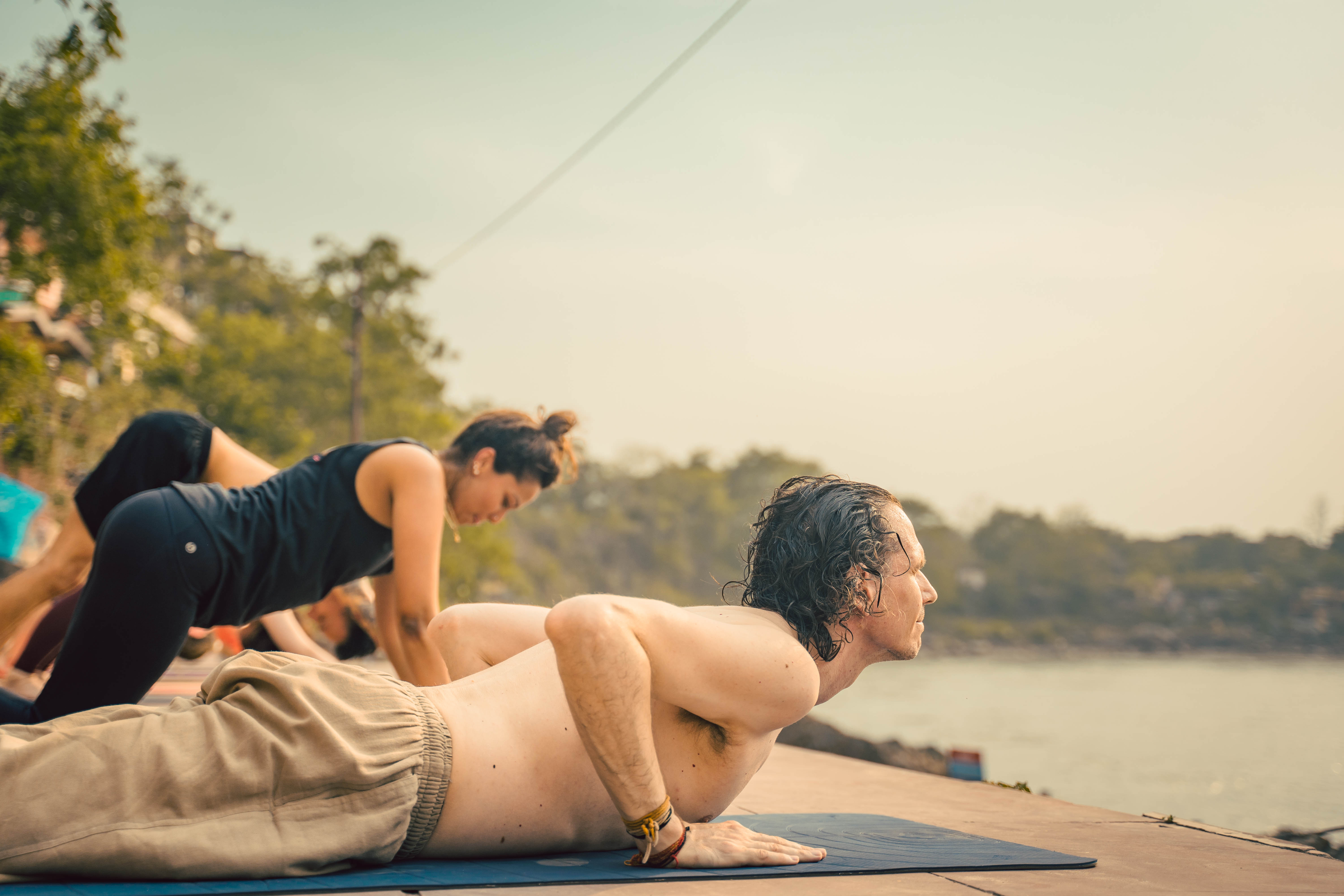 Student meditating by the river